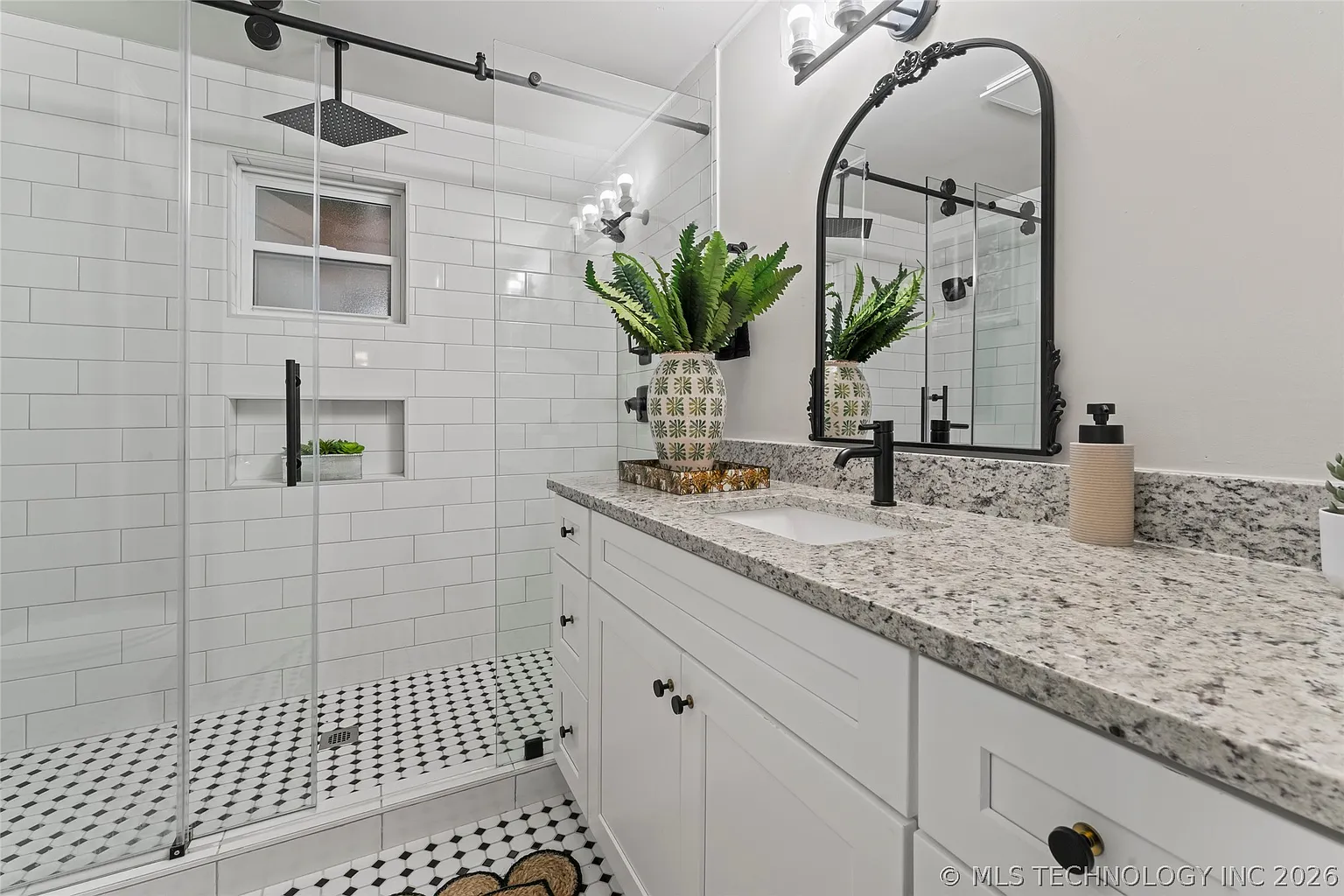 Bathroom remodel with tiled walk-in shower and white vanity