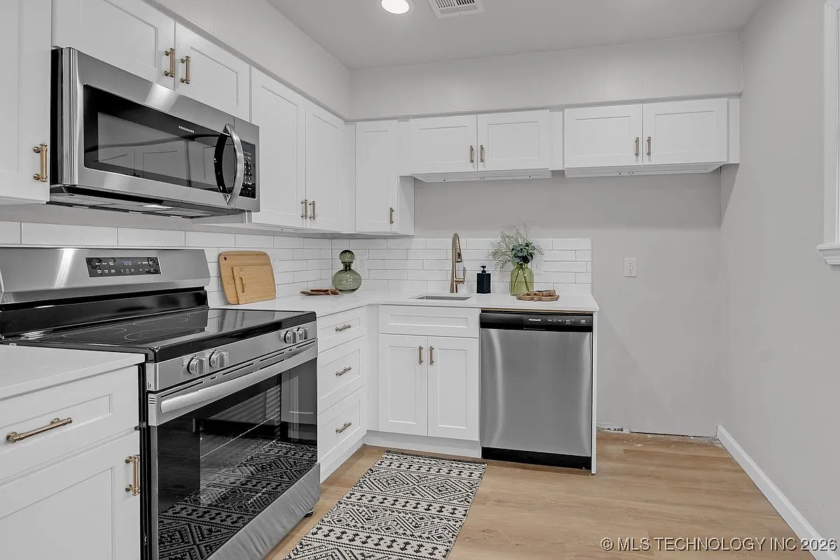 White cabinet kitchen remodel with stainless appliances