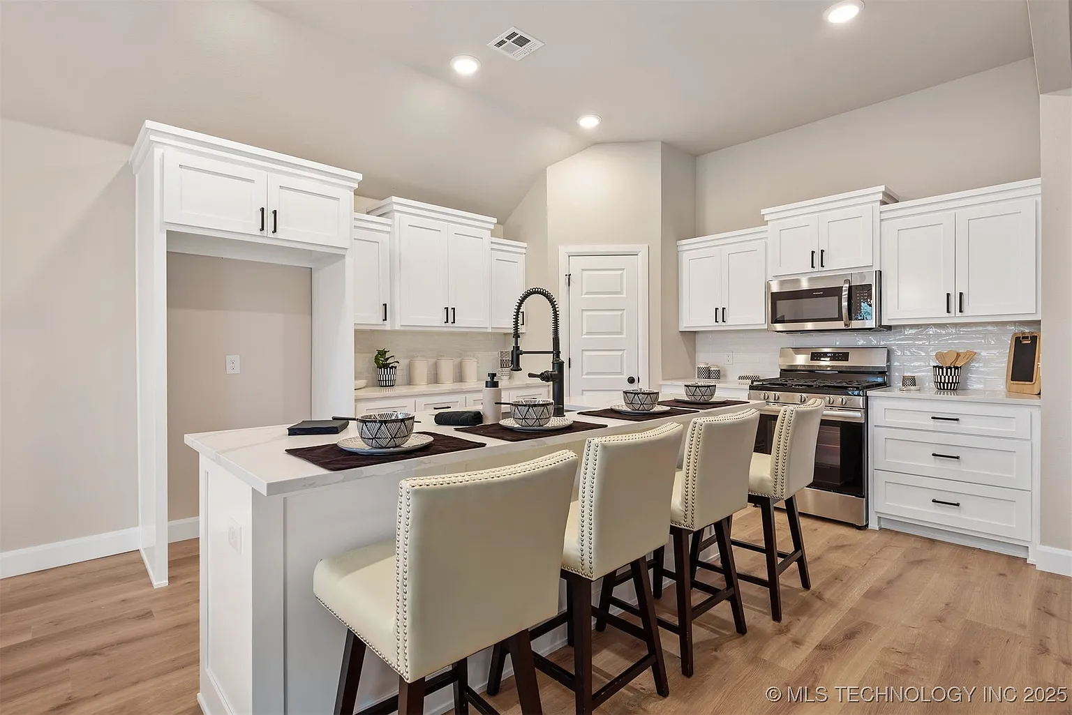 White custom kitchen remodel with large island and seating